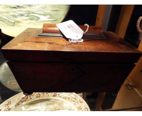 A late Georgian rosewood sarcophagus shaped two section tea caddy, raised on bun feet