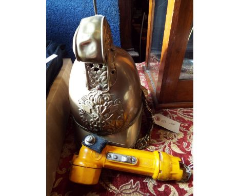 A 19thC brass 'Merryweather' fireman's helmet with  dragon scroll crest and crossed axe , torch badge brass chin strap and le