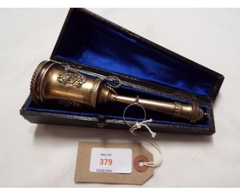A gilded metal posy holder, the handle with ball finial and loop decoration, the holder with fruit and foliate panels, having