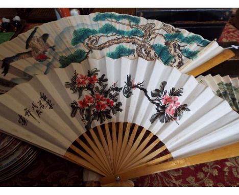 A small quantity of vintage fans, some with hand painted decoration, along with a parasol