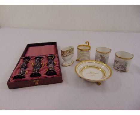 A rare 1835 Schumann Berlin Moabitum Empire cup on a three legged saucer, two early Spode coffee cans circa 1800 and a cased 