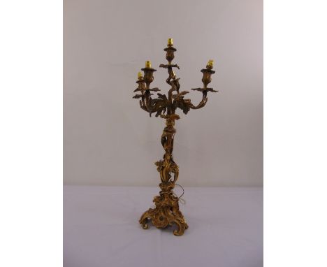 A Baroque style ormolu five light table lamp on scroll pierced triform base