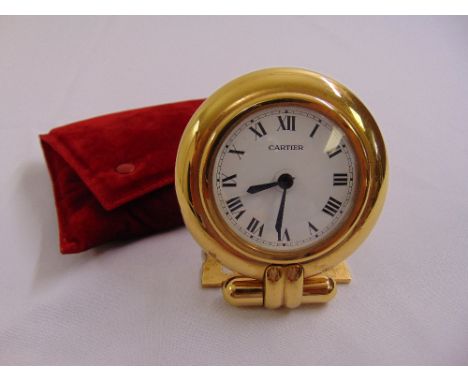 Cartier gilt metal travel clock of circular form white enamel dial with Roman numerals