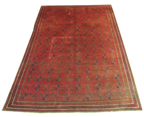 VINTAGE AFGHAN CARPET, 295cm x 200cm, repeat tribal designs on a bordeaux field inside rope twist guard stripes and a trio of