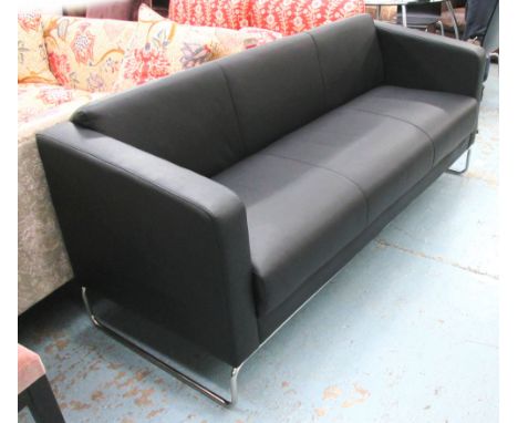 SOFA, three seater, in black leather on chromed metal supports, 189cm L. 