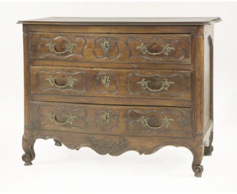 A French walnut serpentine fronted commode,18th century, with three long drawers, carved drawer fronts and gilt metal handles