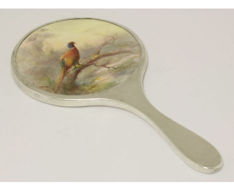 A Royal Worcester silver-mounted hand mirror,painted central panels of a pheasant by James Stinton, signed, the silver mount 