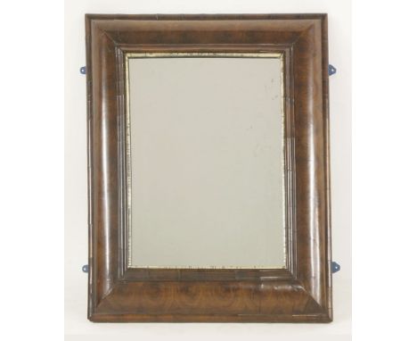 A William and Mary oyster veneered cushion frame wall mirror,with a rectangular plate and silvered bead moulding, 78cm wide90