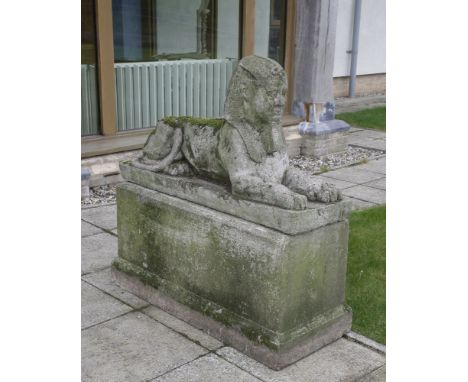 A pair of composition stone sphinx,20th century, each seated on a rectangular plinth,100cm high99cm longPurchased from Charli