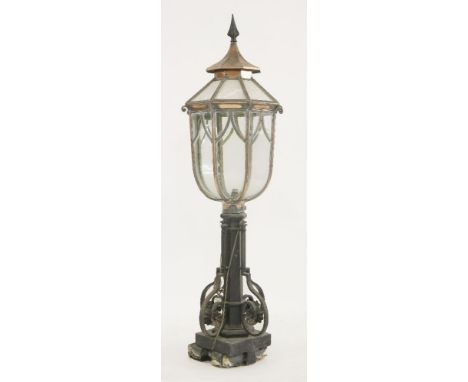 An iron lantern,the copper top with clear plastic panes, wired for electricity,142cm high