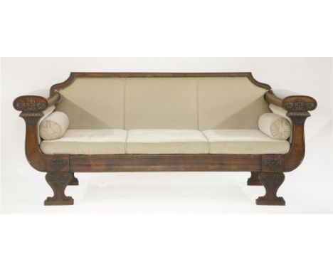 A Regency mahogany settee,the raised back with cushion ends, with classical motifs, on shaped supports with claw feet,220cm w