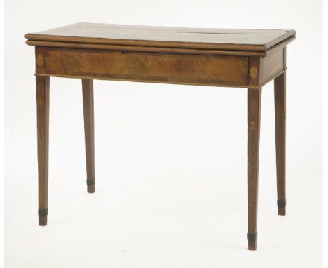 A George III strung and inlaid mahogany fold-over card table,the strung and crossbanded top over a frieze drawer and square t