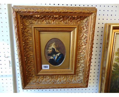 A framed portrait in ornamental frame