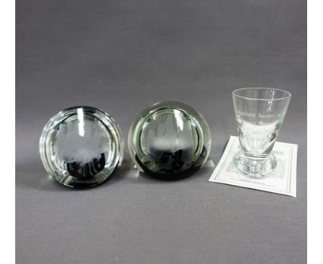 Two Caithness glass limited edition paperweights and a Caithness whisky dram glass, (3) 