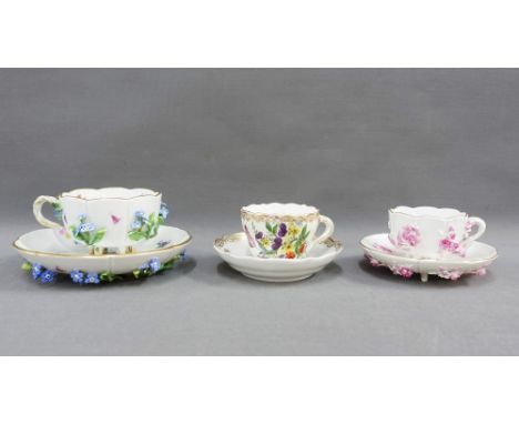 Two Meissen floral encrusted cups and saucers together with a  Meissen floral painted cup and saucer (3)  