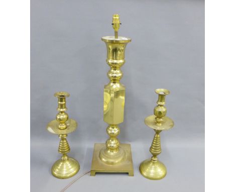 A pair of brass candlesticks together with a large brass knop stemmed table lamp base, 65cm high (3)