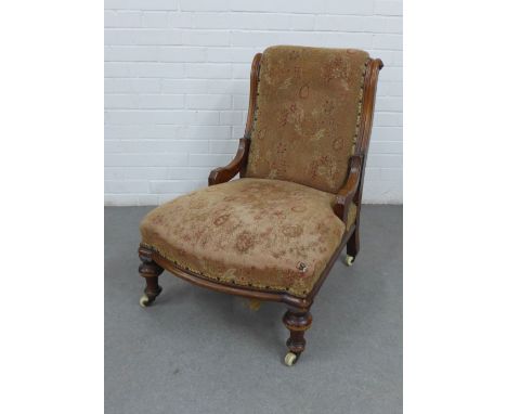 Late 19th century upholstered chair with mahogany frame and legs, with brass caps and ceramic castors, 85 x 63cm