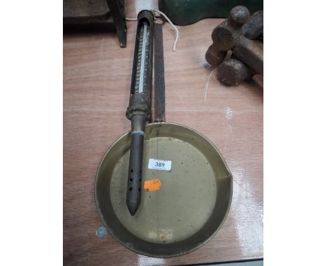A brass pan and thermometer