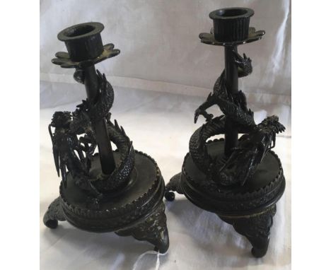 PAIR OF BRONZE ORIENTAL CANDLE STICKS WITH CAST DRAGON DECORATION, BOTH WITH DAMAGED FEET WHICH HAVE BEEN RE-AFFIXED WITH GLU