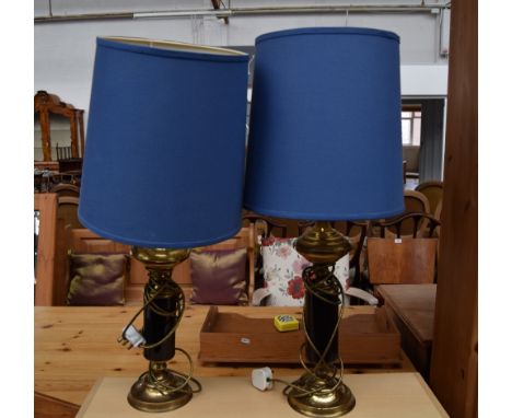 A pair of brass table lamps with black enamel sections and blue fabric shades, 44cmH without shades