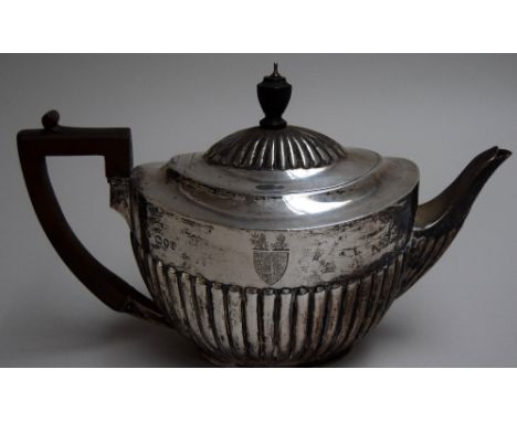 A George III style silver coffee pot of oval lobed form with fruitwood handle and engraved crest, WBJ, London