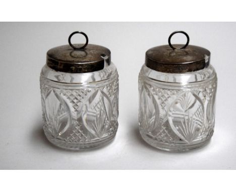 A pair of cut glass and silver lidded preserve pots with cut decoration, Sheffield, marks obscured