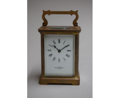 An early 20th century brass carriage timepiece by R and Co, Paris with molded case and enamel dial exported by Mappin and Web