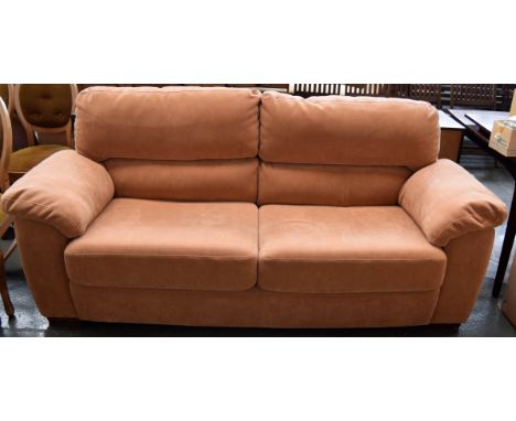 A light brown suede three-seater sofa