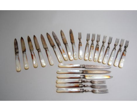 A set of twelve early 20th century fruit knives and forks with mother of pearl handles, stainless steel bodies and silver col