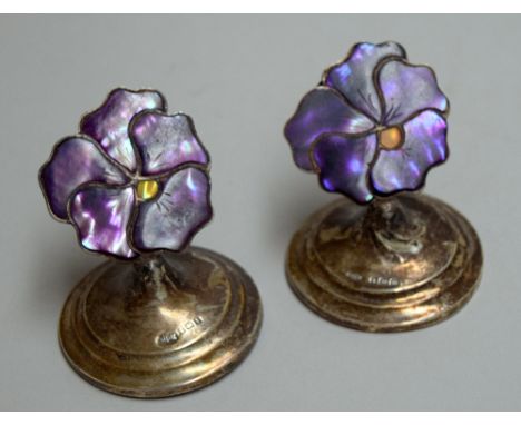 A pair of early 20th century silver and enamel place name holders in the form of pansies, Birmingham 1913, together with a pa