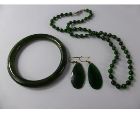 A Green Spinach Jade Bangle, Earrings and Beaded Necklace, necklace approx 49 cms. (3)