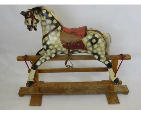 A Vintage Dappled Grey Rocking Horse, with saddle, bridle and horse hair mane and tail.