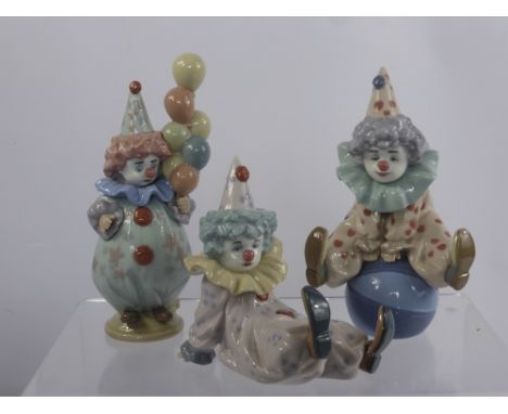 A Trio of Lladro Figurines entitled "Having a Ball" No. 05813, "Littlest Clown" No. 05811 and "Tired Friend" No. 05812 all in