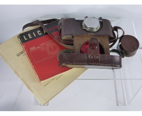A Vintage Leica (Ernst Leitz Weztlar) Camera, no. 278021 dd 1938 together with the Leica camera guide.