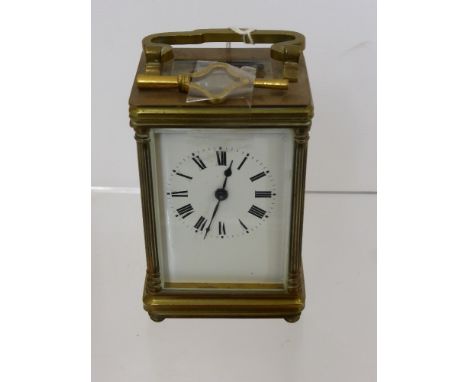 A French Brass Carriage Clock, with enamel face and Roman dial, approx 10 cms