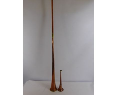 A Copper Hunting Bugle by Henry Keat & Sons,105 Matthias Road, London, together with a copper long horn (2)