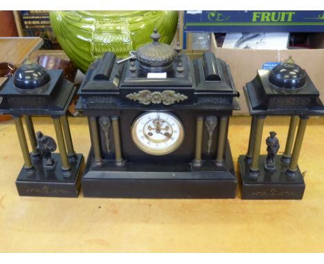 A Black Slate Architectural Mantel Clock with Garniture, the mechanism stamped JJS, the plinth garniture depicting classical 