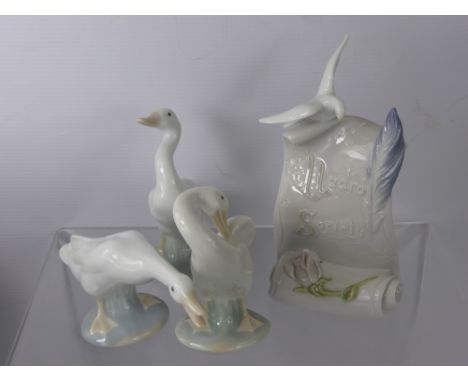 Four Lladro Figurines including Lladro Society Scroll, two figures of geese and one of a duck.