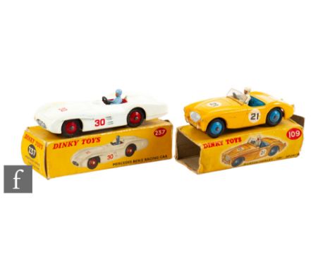 Two Dinky diecast model cars,&nbsp;109 Austin Healey 100 Sports in dark yellow body with racing number 21, windscreen, white 