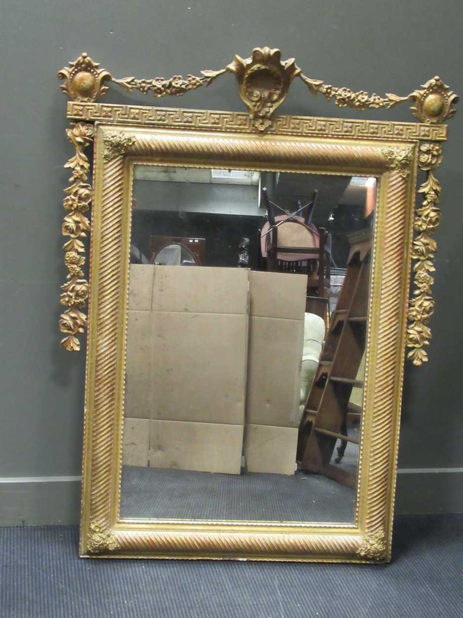A gilt frame mirror with rope twist frame and floral festoons and side