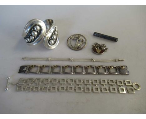 A group of silver jewellery, including three bracelets, two brooches, a bangle and a necklet, gross weight 149.2g (7)