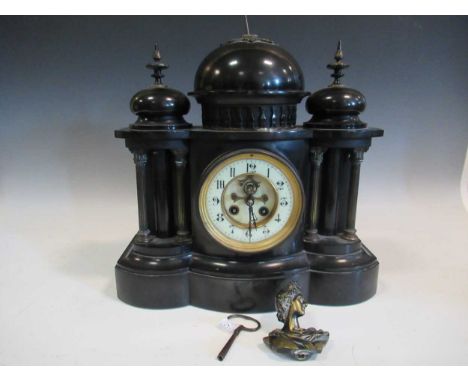 A black slate mantle clock, the central finial in the form of a classical bust