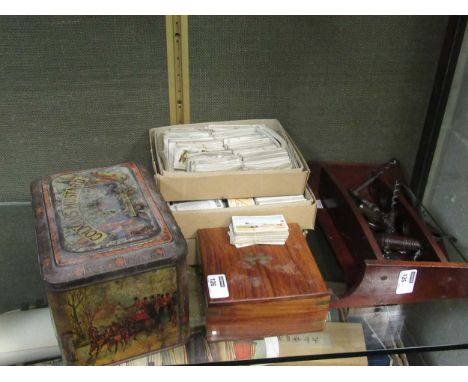 A Colman's Mustard tin, loose cigarette cards, corkscrews and a reproduction brass compass