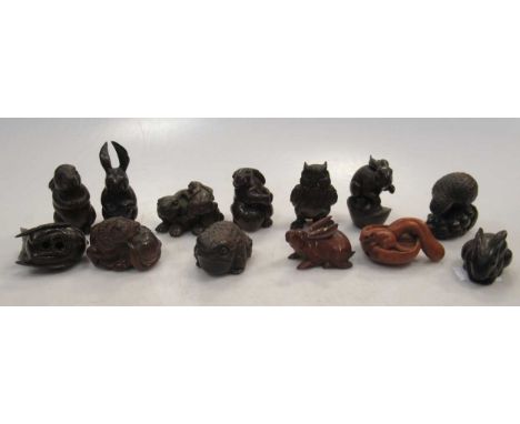 Thirteen carved wood animal netsuke, including 7 rabbits or hares, frog, owl, a quail, buffalo etc