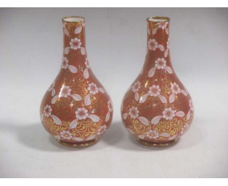 A pair of 19th century Copeland Spode bottle vases, the burnt orange ground bodies decorated with flowers and extensively gil