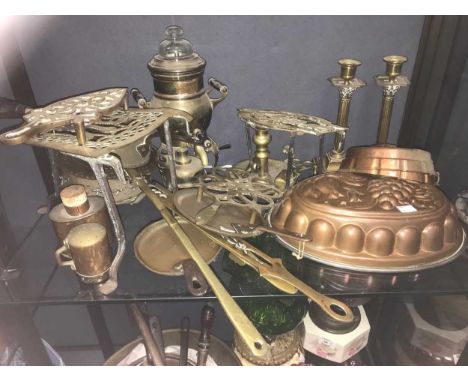 A large collection of copper and brassware, to include kettles, jam pan, trivets, moulds, candlesticks, percolator, mortar an