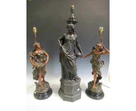 A large figural bronzed lamp base together with a pair of patinated spelter figural lamp bases