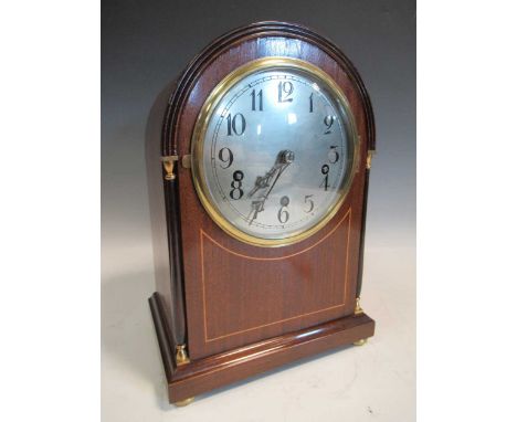 A German mahogany dome top mantel clock, 3 dong chiming movement, on brass disc feet.