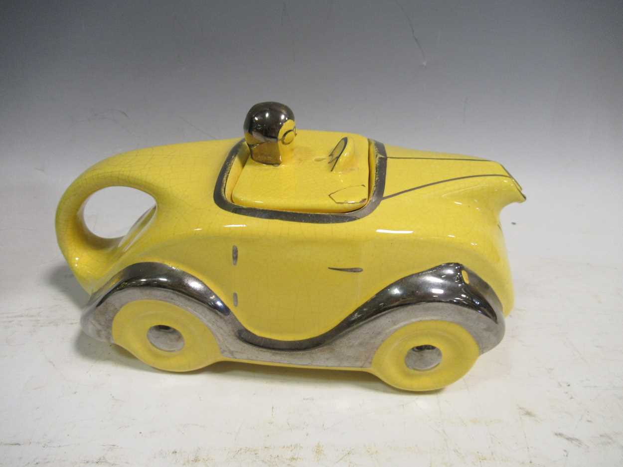 A sadler racing car teapot and a Doulton lambeth vase in Cheffins