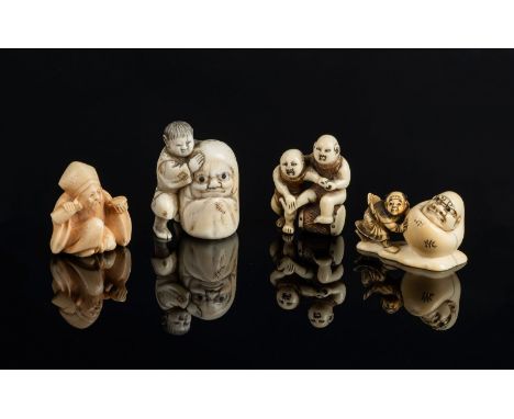 Japanese Art. A group of four netsuke Japan. 19th century. Two Karako on a drum (h. 4cm)  Karako e Daruma signed Shigemasa (h